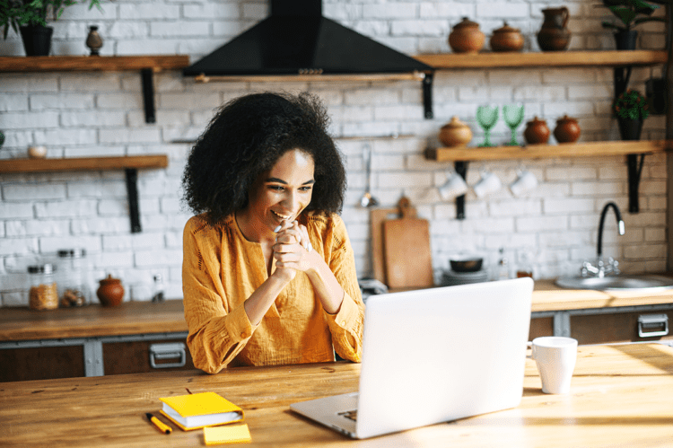 woman looking at her computer talking to someone